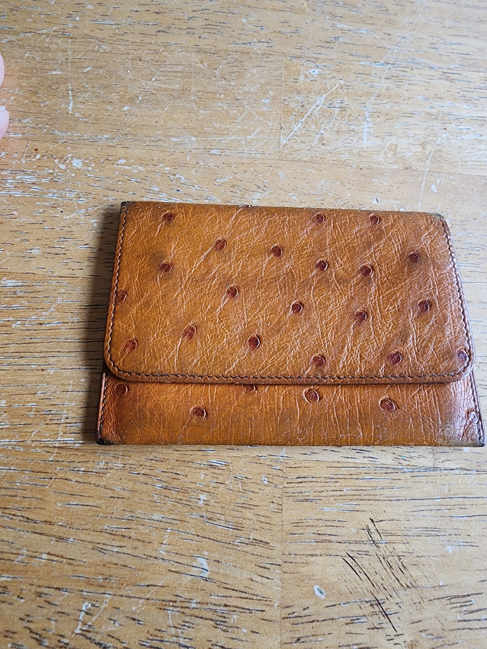 vintage Hermès wallet is crafted from genuine cognac ostrich leather.